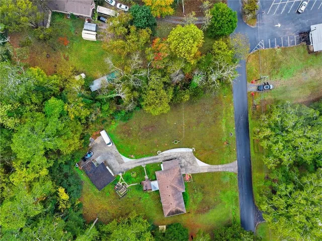 an aerial view of a house with a yard basket ball court and outdoor seating