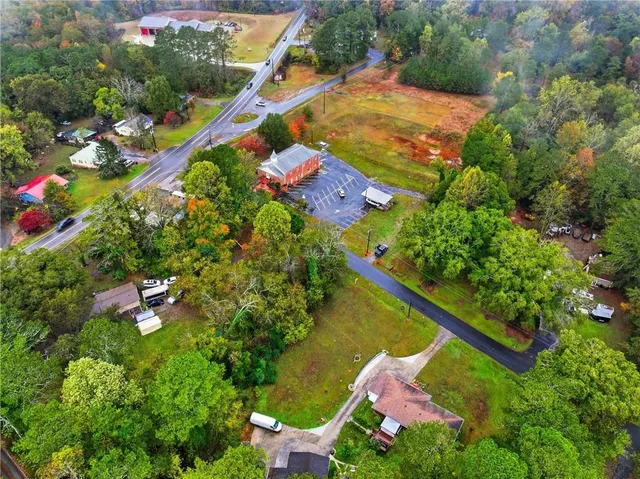 an aerial view of a residential houses with outdoor space and street view