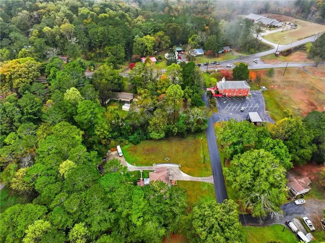 an aerial view of a house with a yard swimming pool outdoor seating and yard
