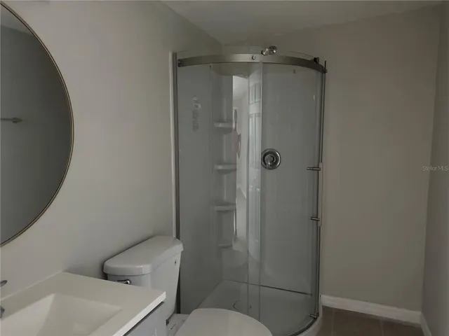 a bathroom with a shower and toilet