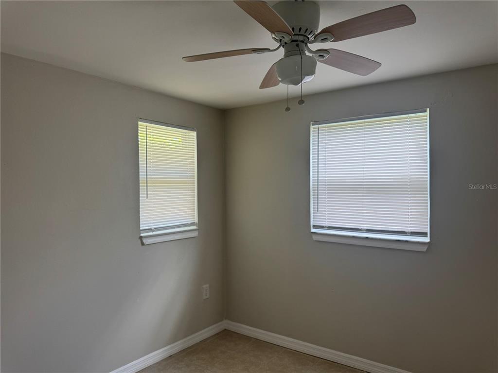 809 West Warren Street Plant City, FL 33563 - Photo 12 of 28 an empty room with a window and a fan