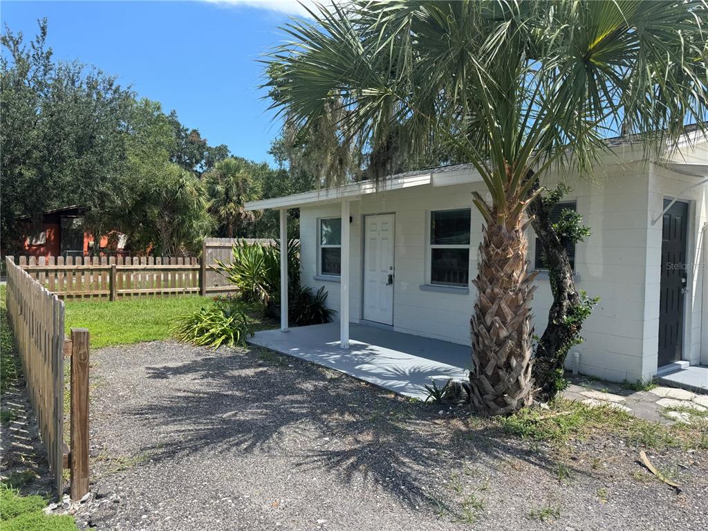 809 West Warren Street Plant City, FL 33563 - Photo 14 of 28 a view of a house with a yard and a large tree