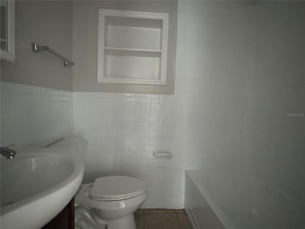 809 West Warren Street Plant City, FL 33563 - Photo 16 of 28 a white toilet sitting next to a shower