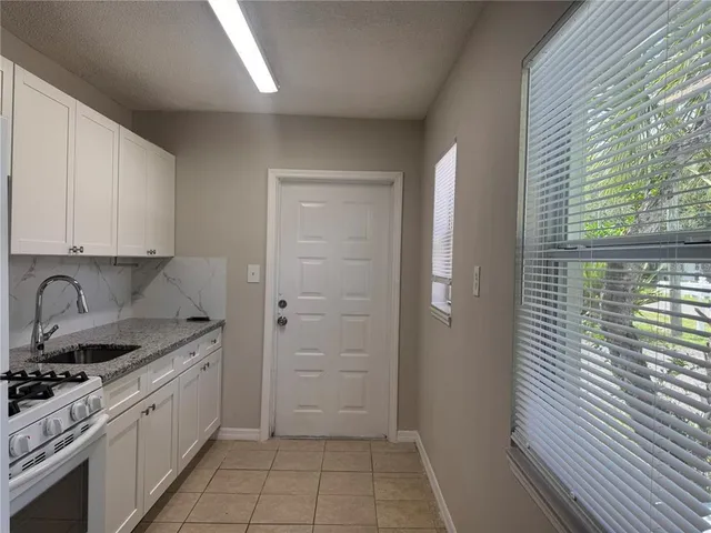 a kitchen with a sink stove and cabinets