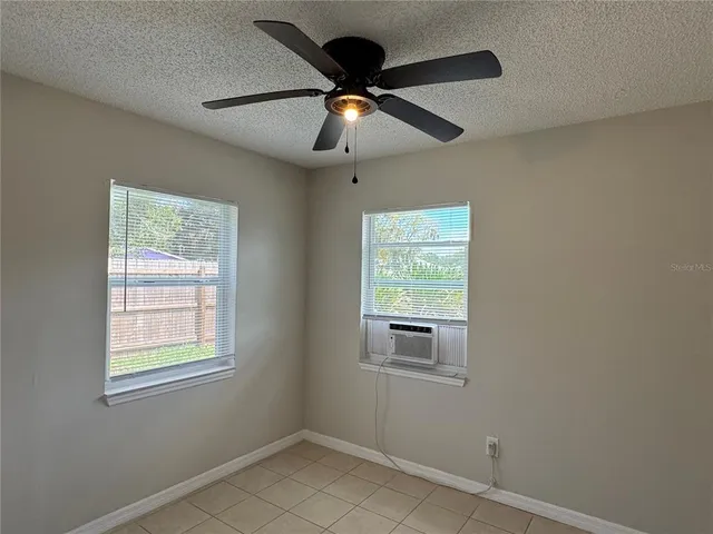 a room with window and ceiling fan