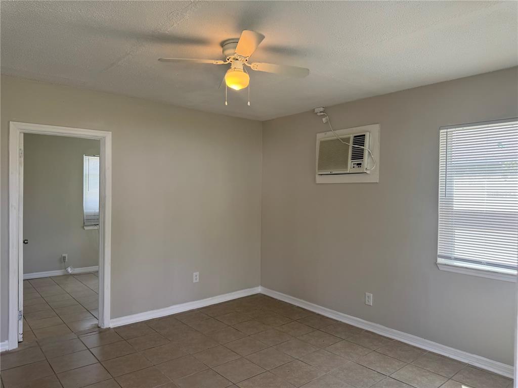 809 West Warren Street Plant City, FL 33563 - Photo 24 of 28 an empty room with window and chandelier fan