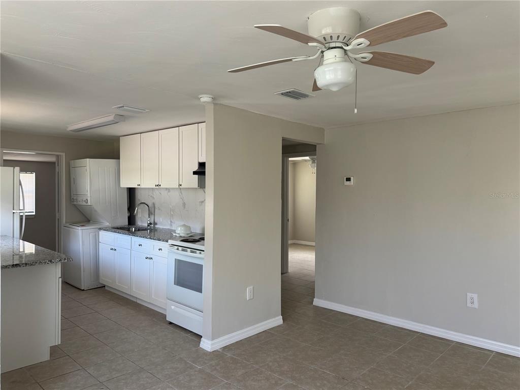 809 West Warren Street Plant City, FL 33563 - Photo 8 of 28 a kitchen with stainless steel appliances a white stove top oven and cabinets