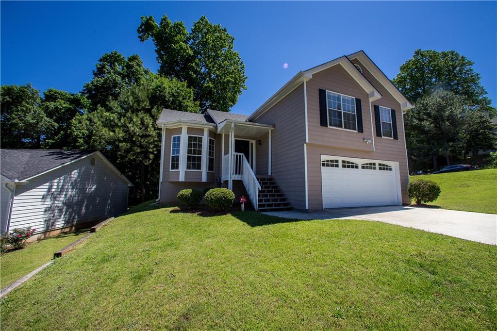 5735 Hollow Ridge Lane Norcross, GA 30071 - Photo 1 of 1 a front view of a house with a yard and garage
