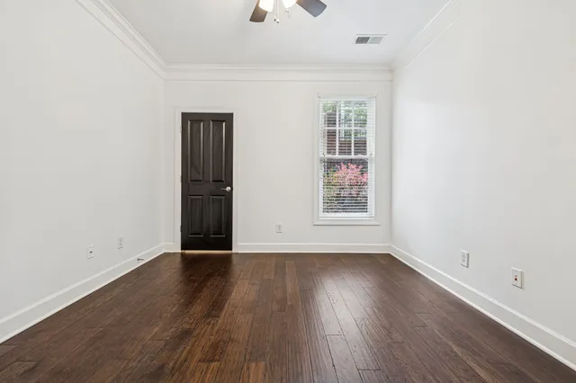 wooden floor & wooden door in an empty room