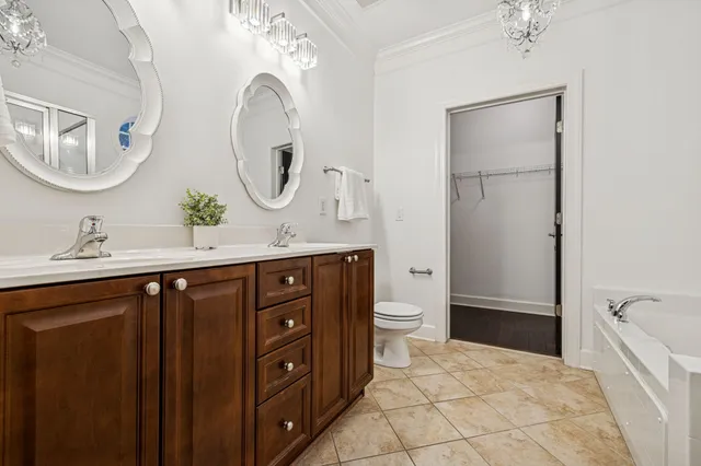 a bathroom with a granite countertop sink a mirror and a shower