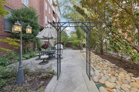 a view of a patio with a table and chairs under an umbrella