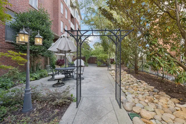 a view of a patio with a table and chairs under an umbrella