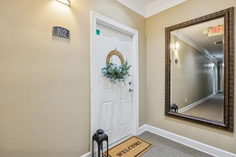 a view of a livingroom with wooden floor and a ceiling fan