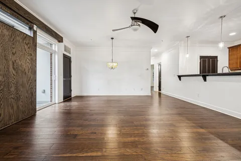 a living room with furniture and a view of kitchen