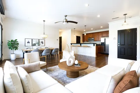a view of a kitchen with a refrigerator and a stove top oven