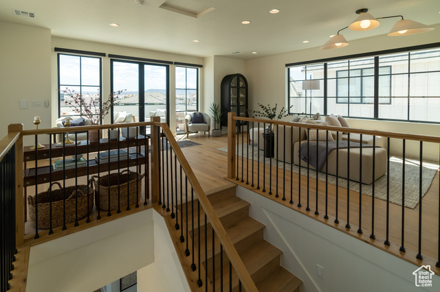 5366 Cyan Lane St. George, UT 84790 - Photo 20 of 39 Stairs featuring healthy amount of natural light, wood finished floors, and recessed lighting