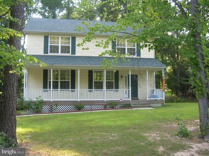 8405 Tee Road Lusby, MD 20657 - Photo 1 of 19 front view of a house with a yard
