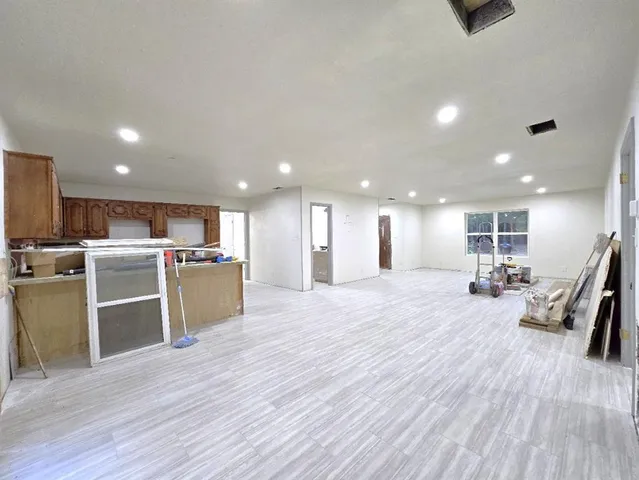a view of a kitchen with furniture and wooden floor