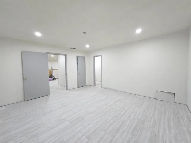 a view of an empty room with wooden floor