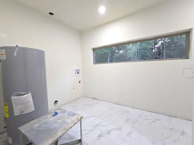a view of a big room with wooden floor and windows