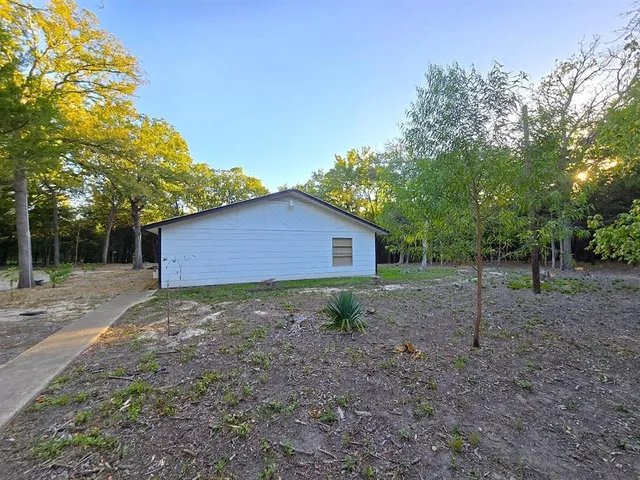 a backyard of a house with lots of green space