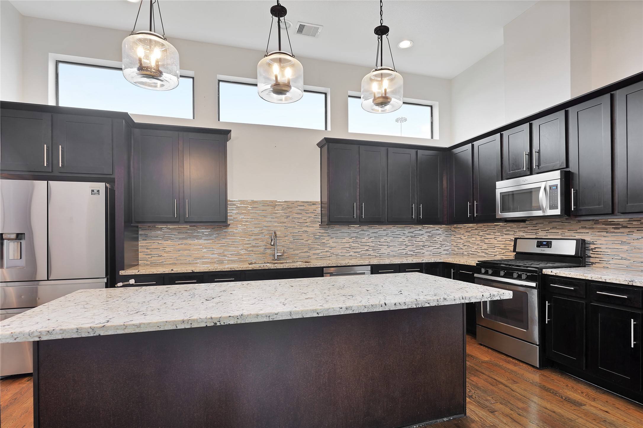 1810 Thompson Street Houston, TX 77007 - Photo 5 of 20 a kitchen with stainless steel appliances granite countertop a sink a stove and a refrigerator