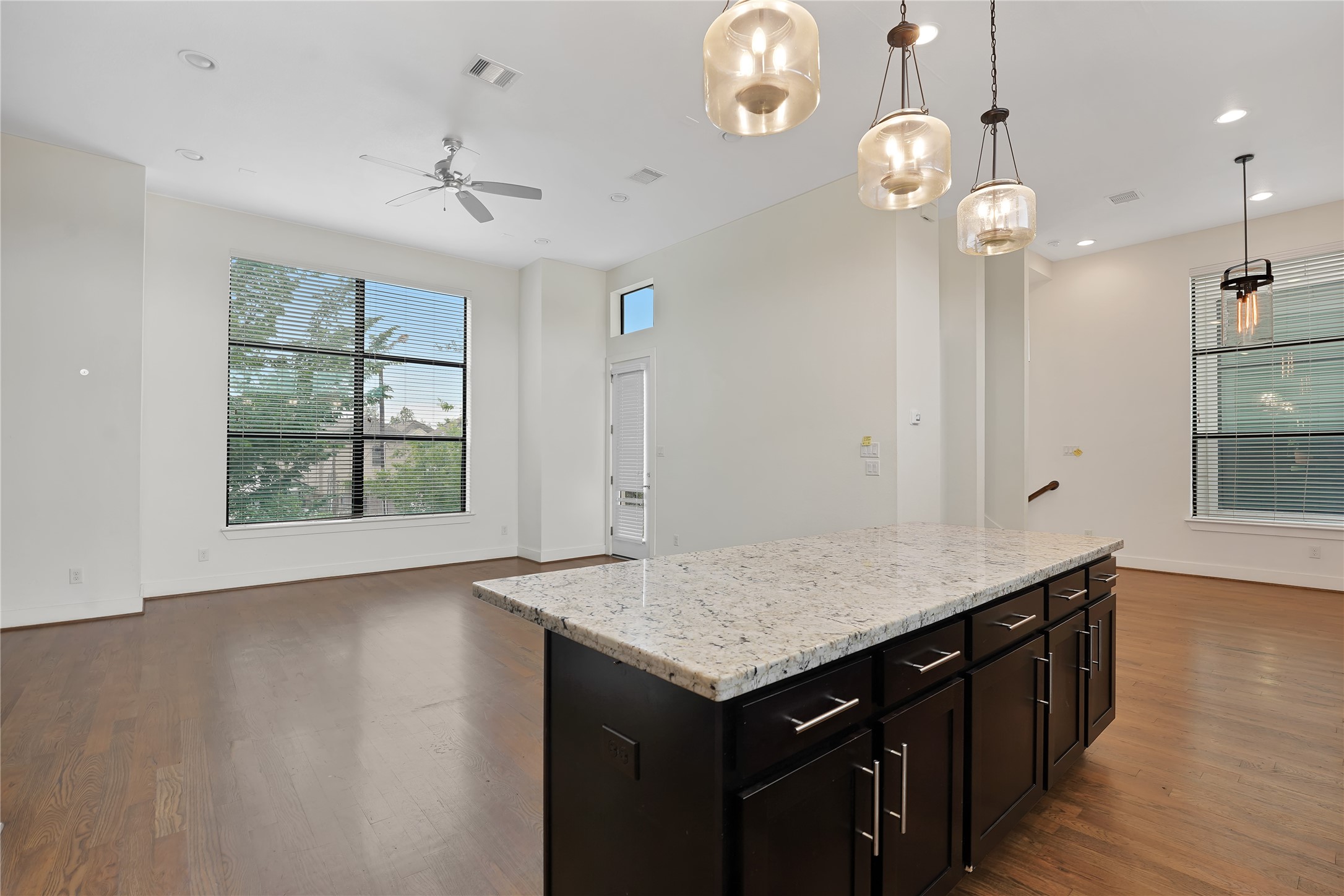 1810 Thompson Street Houston, TX 77007 - Photo 7 of 20 an empty room with wooden floor and windows