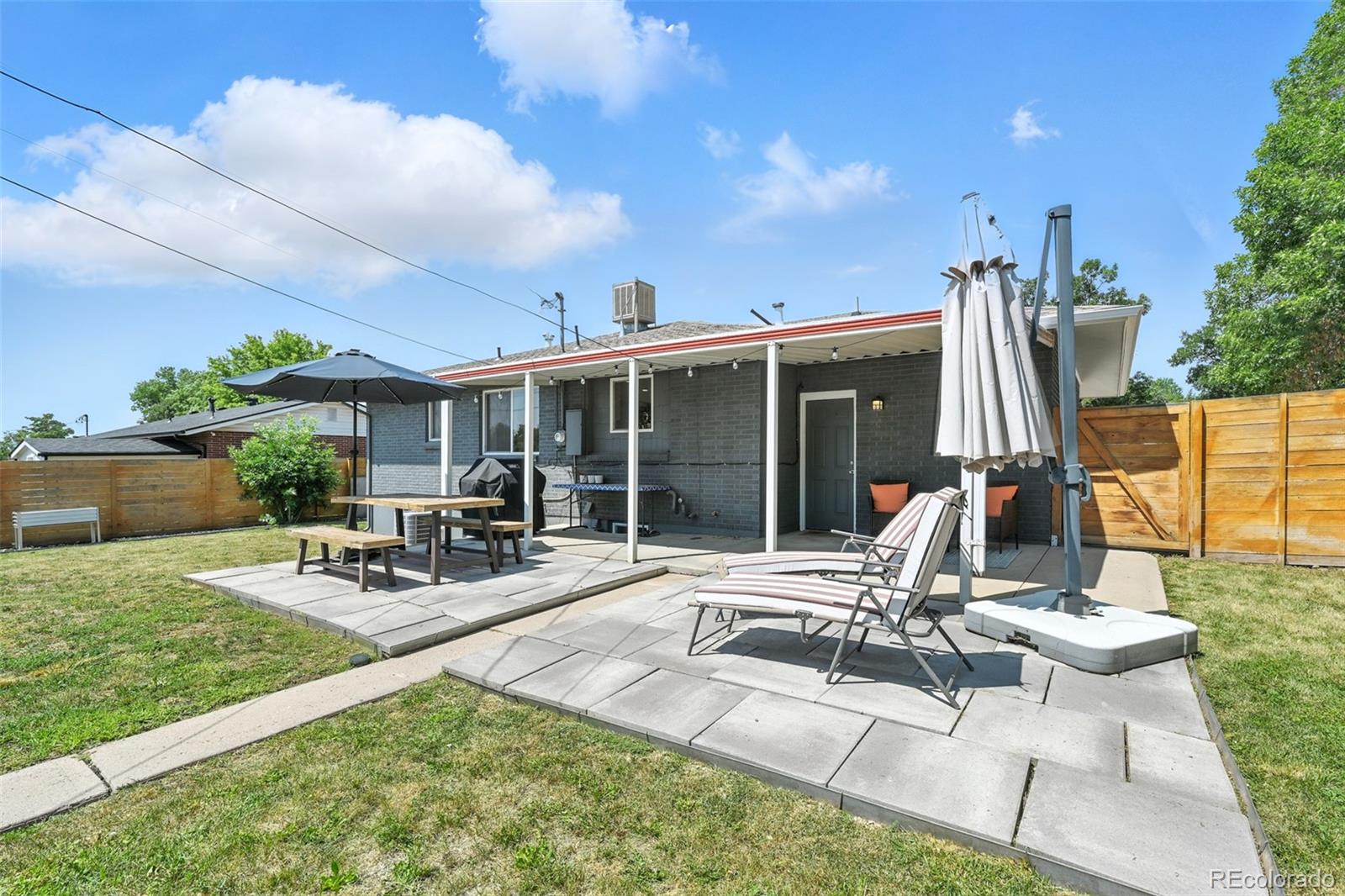 2714 South Raleigh Street Denver, CO 80236 - Photo 31 of 34 a view of a patio with table and chairs and potted plants