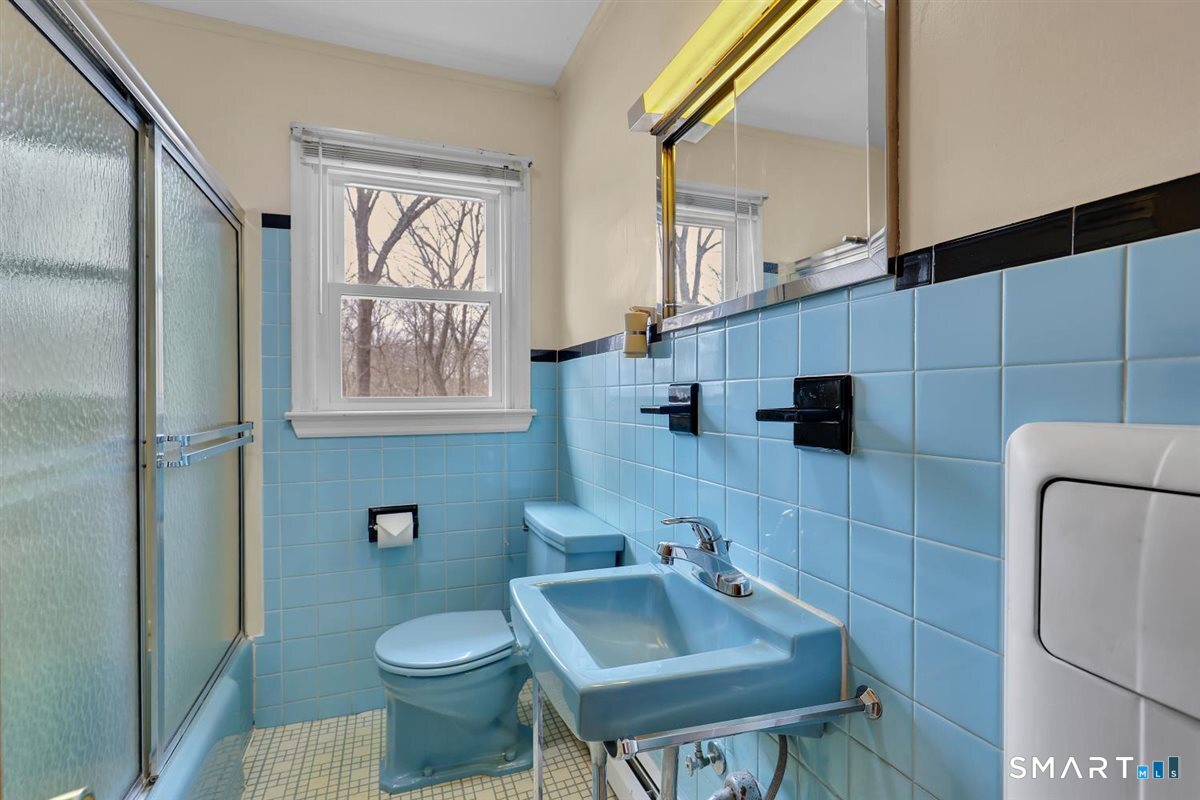 47 Park Road Colchester, CT 06415 - Photo 11 of 31 Classic retro-blue tiled bath with tub and shower combo. This bath features a vintage mid-century modern metal laundry hamper.
