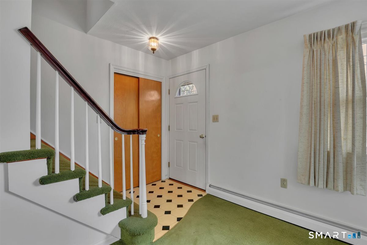 47 Park Road Colchester, CT 06415 - Photo 16 of 31 Bright entry foyer offering practical storage with a spacious coat closet and durable flooring for easy cleanup. Quick access to the second floor bedrooms.