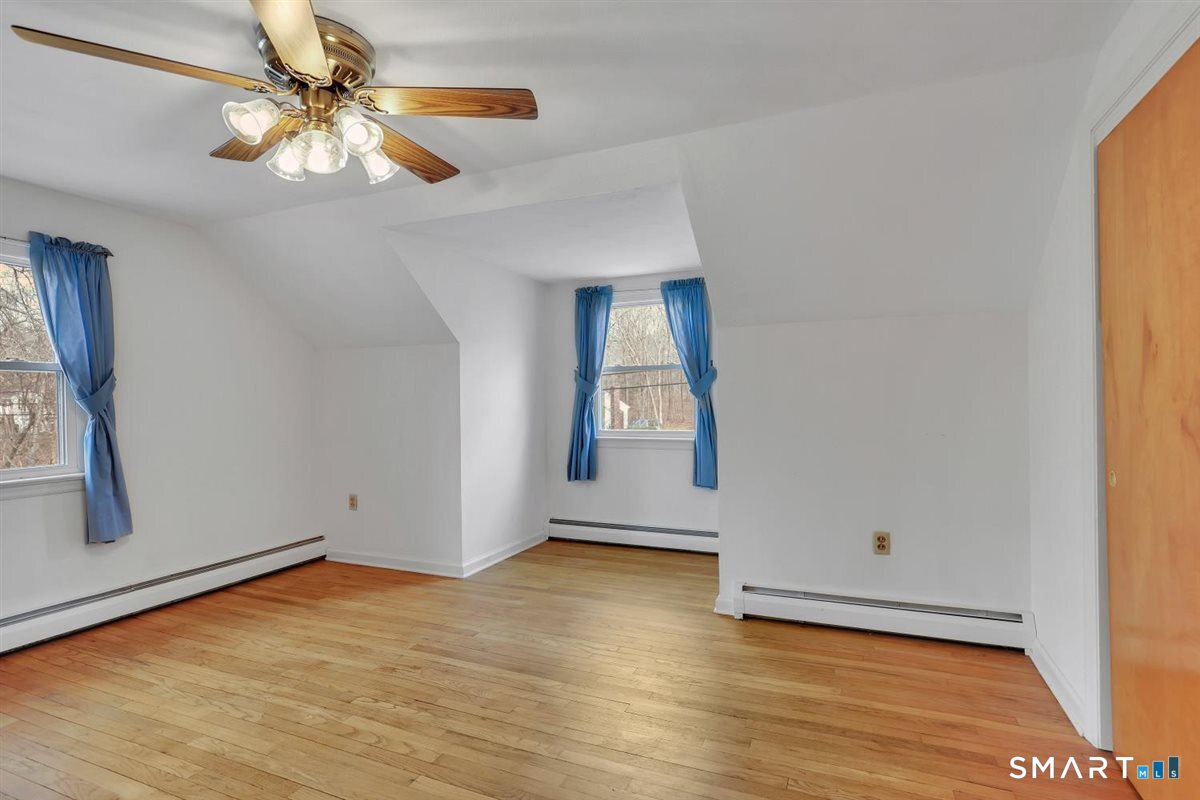 47 Park Road Colchester, CT 06415 - Photo 17 of 31 Bright and airy second-floor bedroom with warm wood accents, modern ceiling fan and light, and ample closet space.