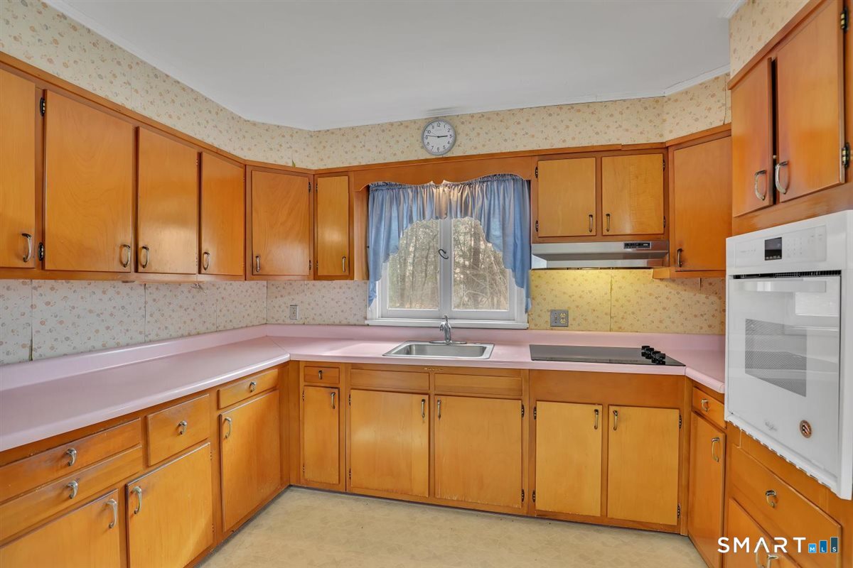 47 Park Road Colchester, CT 06415 - Photo 4 of 31 Spacious kitchen featuring ample storage, generous counter prep areas, and a dedicated eat-in space. This bright, functional room offers classic vintage appeal and immense potential.