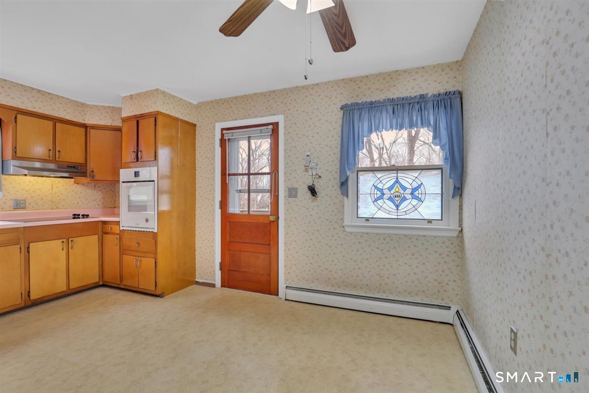 47 Park Road Colchester, CT 06415 - Photo 10 of 31 The kitchen offers signature retro finishes, providing a clean and cozy heart of the home. And check out that custom stained glass window!