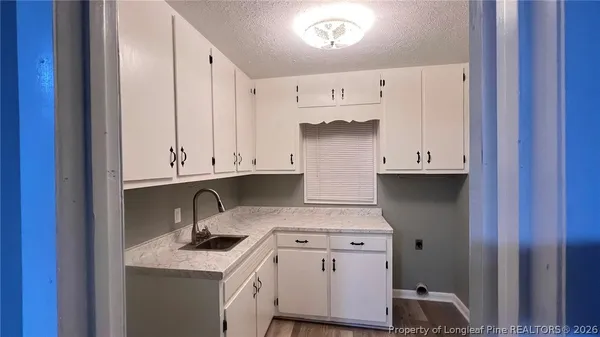 a kitchen with a sink stove and cabinets