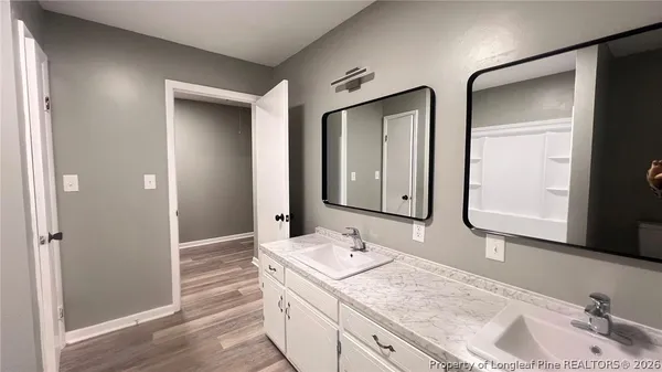a bathroom with a granite countertop sink and a mirror