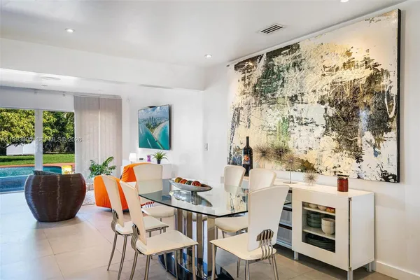 a dining room with furniture and window