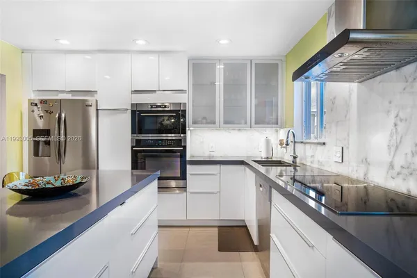 a kitchen with stainless steel appliances granite countertop a sink and a stove