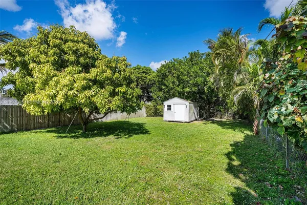 a view of a house with a yard and garden