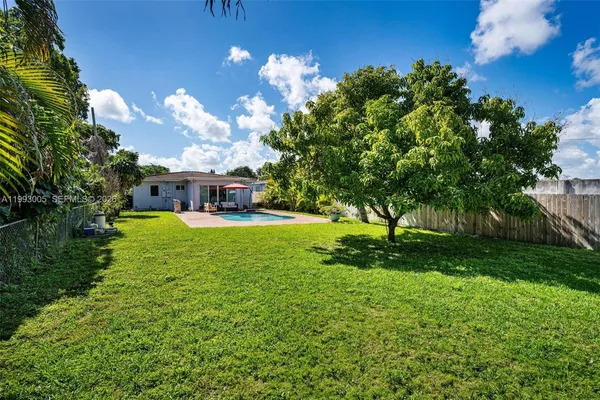 a view of a house with swimming pool and sitting area