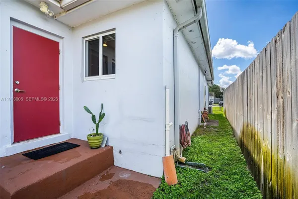a large white kitchen with stainless steel appliances granite countertop a stove a sink dishwasher and white cabinets with wooden floor