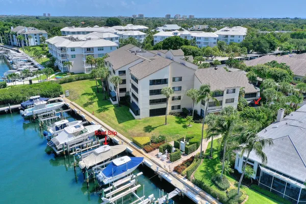 an aerial view of a house with garden space and lake view