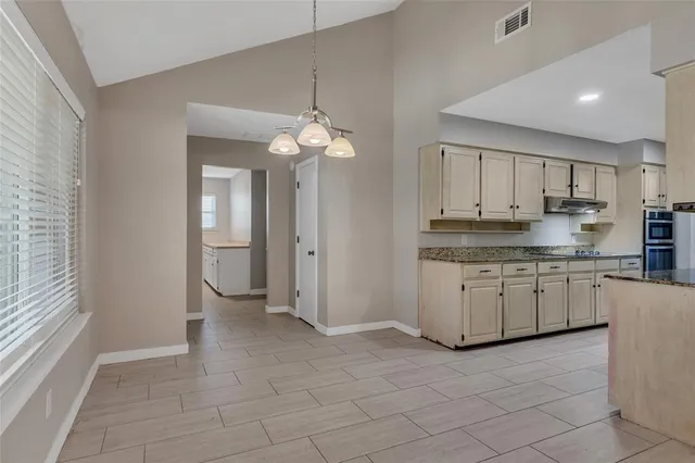a kitchen that has a lot of cabinets in it