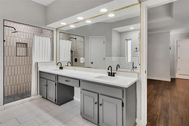 a bathroom with a sink double vanity and a mirror