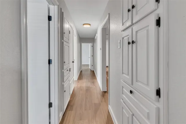 a view of a hallway with a wooden floor