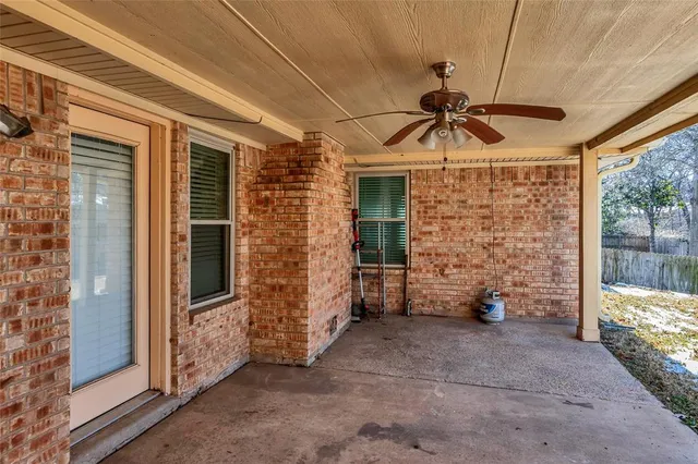 a view of a porch with couches and table and chairs