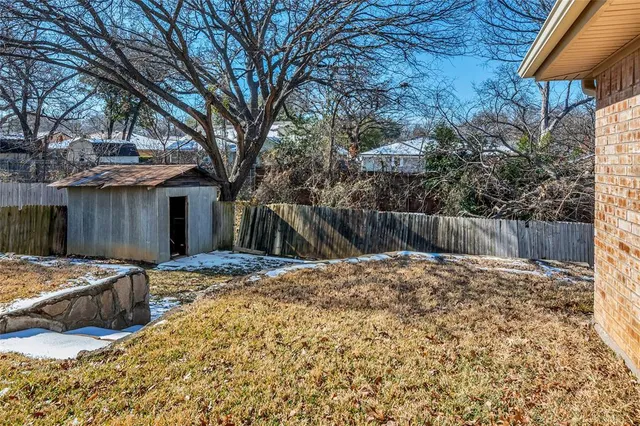 a backyard of a house with barbeque oven