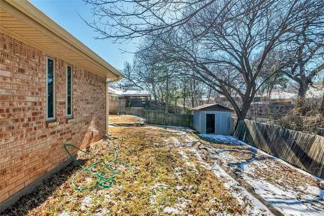 a yellow house with trees in front of it