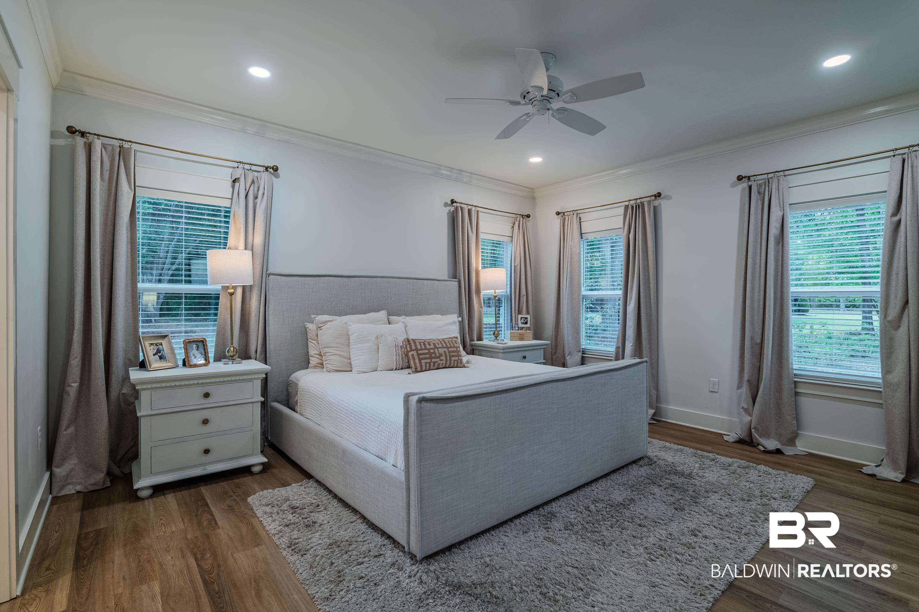 19121 Boothe Road Fairhope, AL 36532 - Photo 17 of 41 Bedroom featuring ceiling fan, recessed lighting, dark wood-type flooring, and crown molding