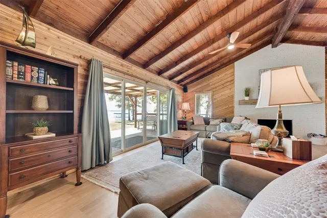 a living room with furniture a window and a flat screen tv