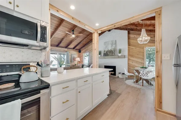 a kitchen with sink cabinets and wooden floor